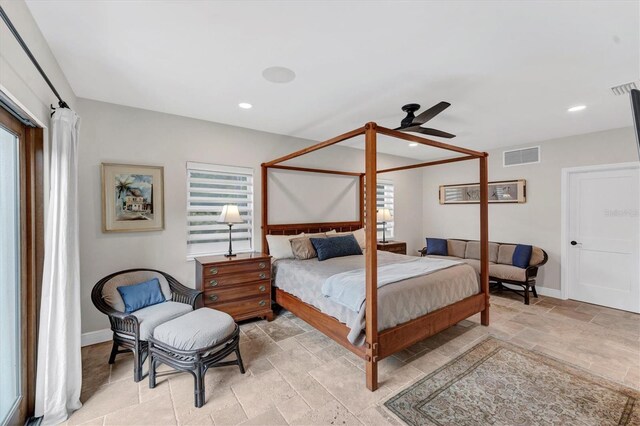 bedroom with multiple windows and ceiling fan