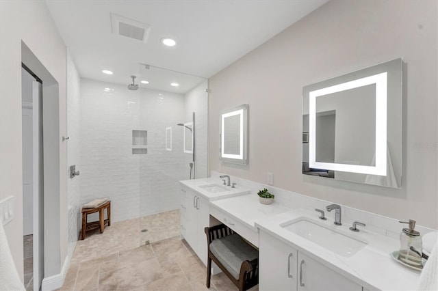 bathroom featuring vanity and a tile shower