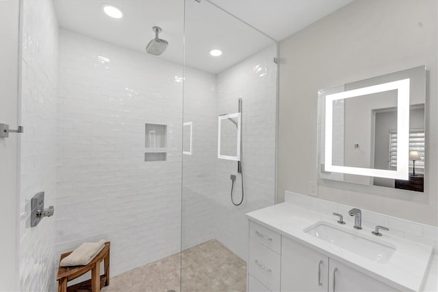 bathroom with vanity and tiled shower