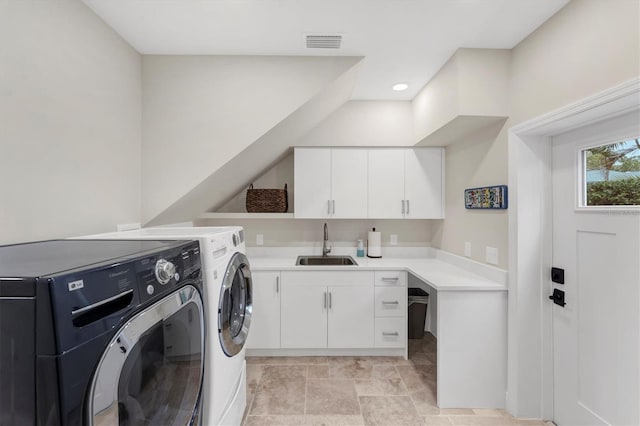 laundry area with cabinets, sink, and washer and dryer