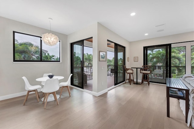 dining room with wood-type flooring and a notable chandelier