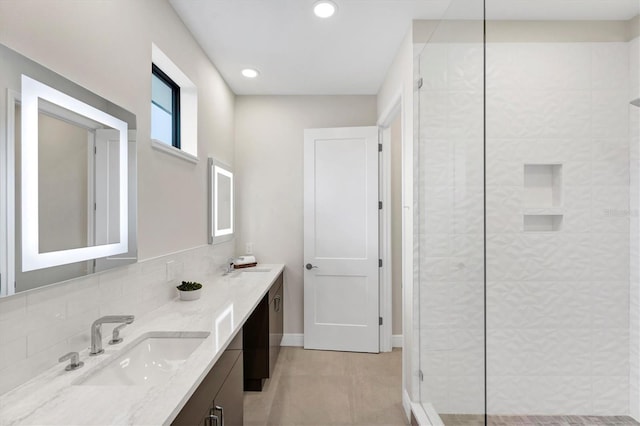 bathroom featuring a shower, vanity, tile patterned floors, and backsplash