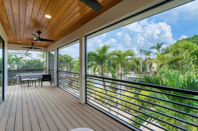 wooden deck featuring ceiling fan