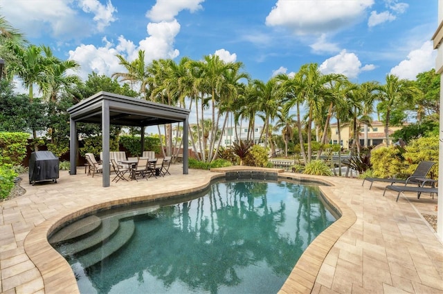 view of swimming pool with a gazebo, a patio area, and a grill