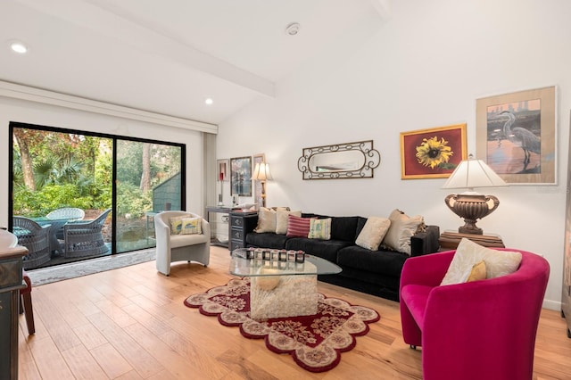 living room featuring light hardwood / wood-style floors and vaulted ceiling with beams