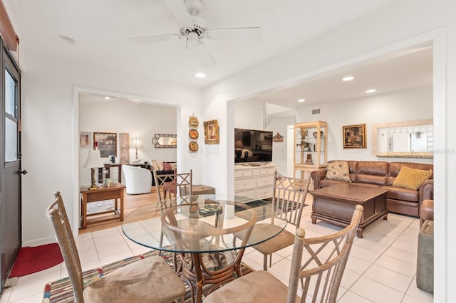 tiled dining space with ceiling fan