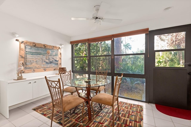 tiled dining space featuring ceiling fan