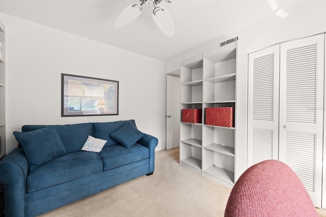 carpeted living room featuring ceiling fan