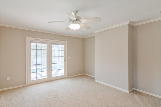 empty room featuring light carpet, ceiling fan, and ornamental molding