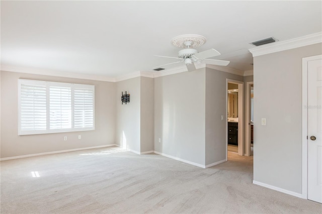 carpeted empty room with ceiling fan and ornamental molding