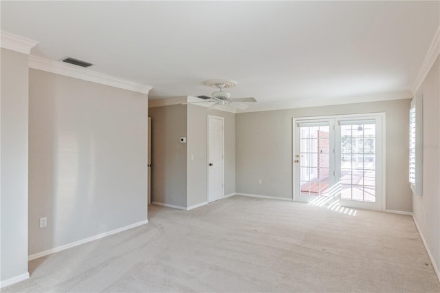 carpeted empty room featuring ceiling fan and crown molding