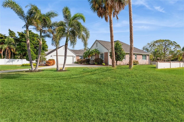 ranch-style house featuring a front yard and a garage