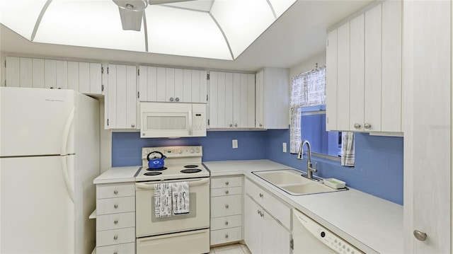 kitchen featuring white cabinetry, white appliances, and sink