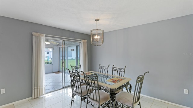 dining area with light tile patterned floors, a textured ceiling, and a notable chandelier