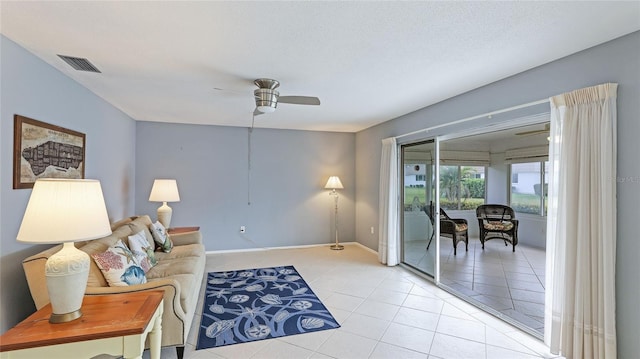 living room with ceiling fan and light tile patterned flooring