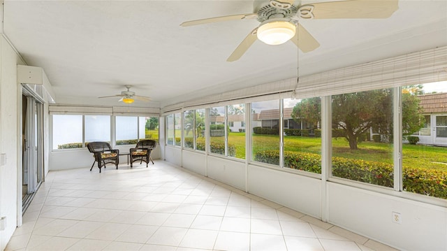 unfurnished sunroom with ceiling fan