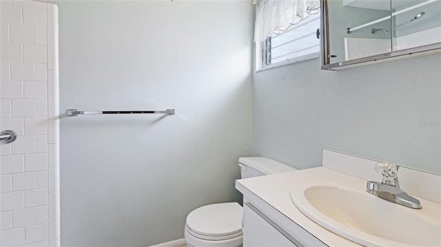 bathroom featuring vanity, toilet, and a shower