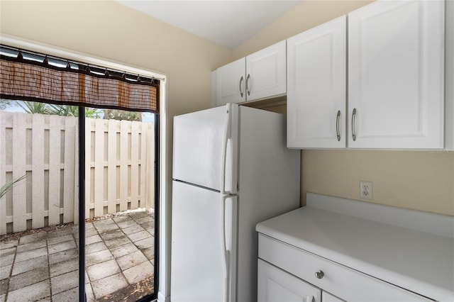 kitchen with white cabinets and white refrigerator