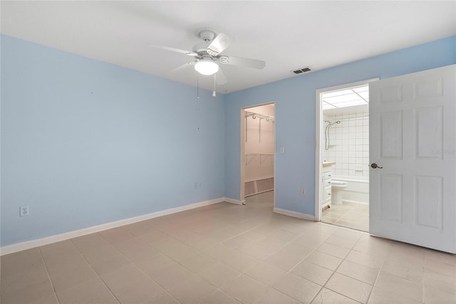 unfurnished bedroom featuring a walk in closet, ceiling fan, light tile patterned floors, connected bathroom, and a closet