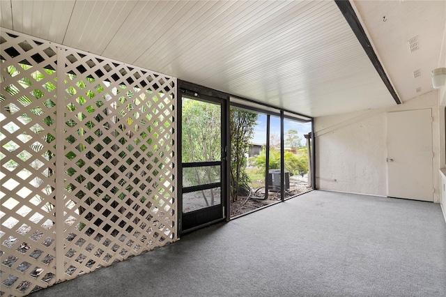 unfurnished sunroom featuring beamed ceiling