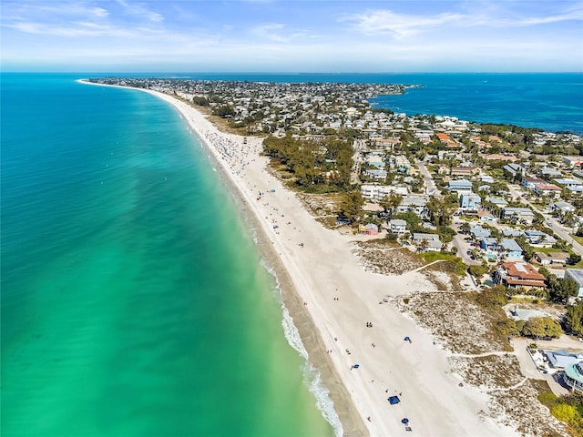 drone / aerial view featuring a beach view and a water view