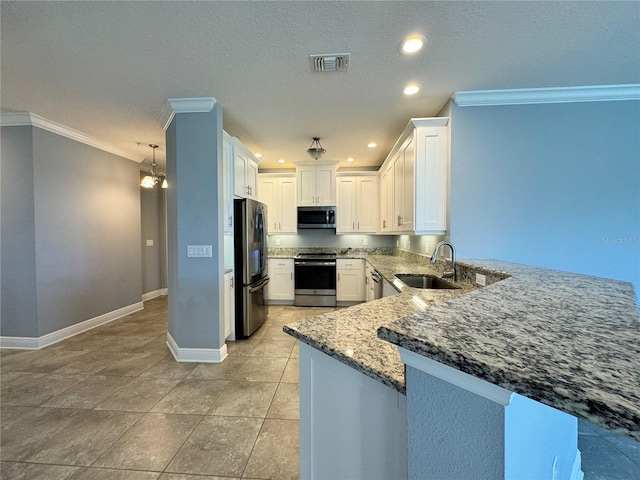 kitchen featuring white cabinets, sink, dark stone countertops, kitchen peninsula, and stainless steel appliances