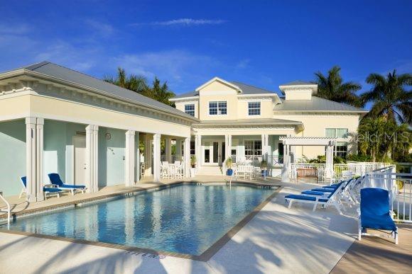 rear view of property with a patio area, a pergola, and a community pool