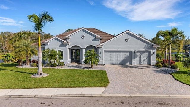 view of front of house featuring a garage and a front yard