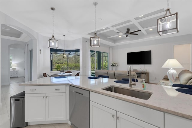 kitchen with sink, coffered ceiling, stainless steel dishwasher, decorative light fixtures, and white cabinets