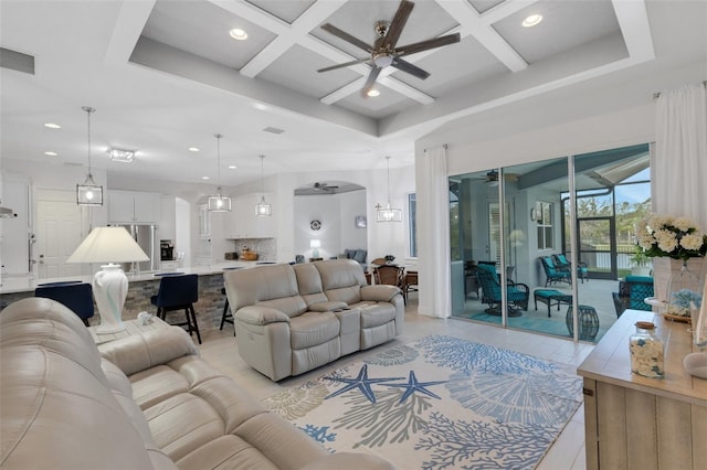 tiled living room with beamed ceiling, ceiling fan, and coffered ceiling