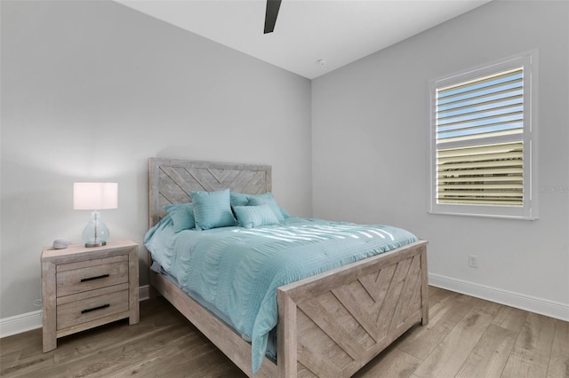 bedroom with hardwood / wood-style floors and ceiling fan