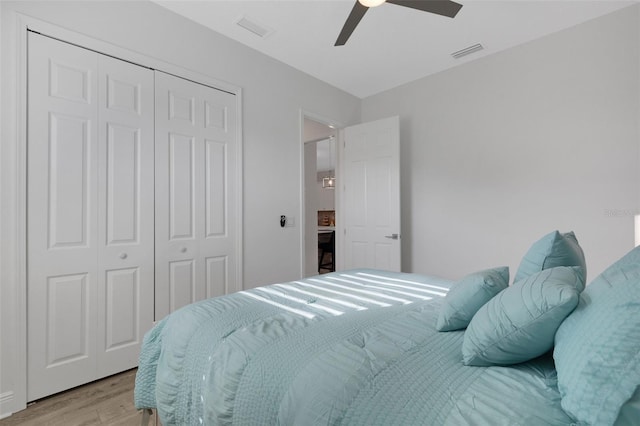 bedroom featuring ceiling fan, a closet, and light hardwood / wood-style floors