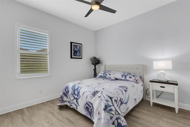 bedroom with ceiling fan and wood-type flooring