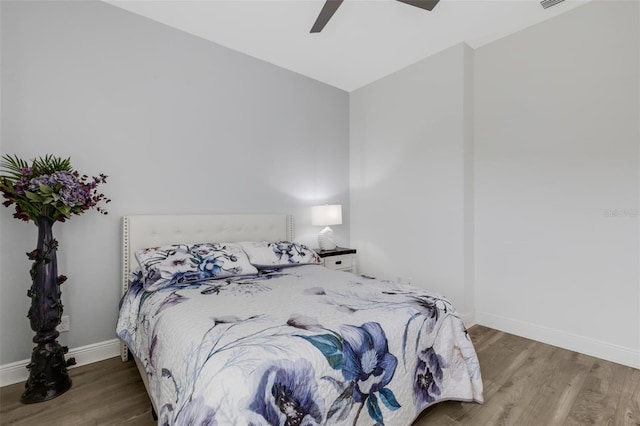 bedroom with ceiling fan and hardwood / wood-style flooring