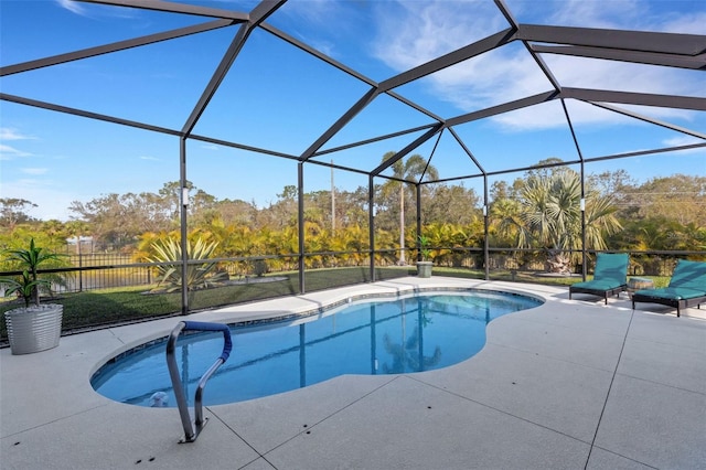 view of swimming pool featuring a lanai and a patio area