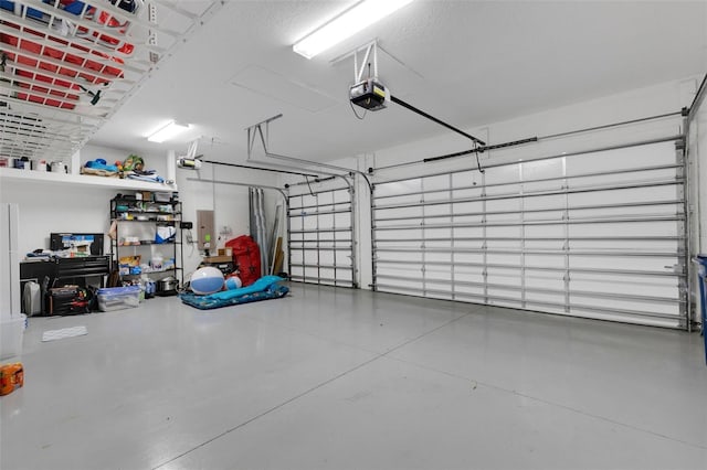 garage with electric panel and a garage door opener