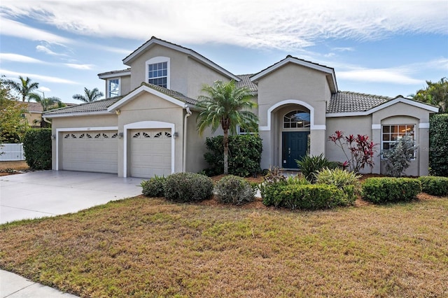 view of front of home featuring a front yard, central AC, and a garage