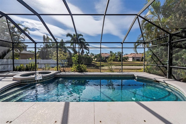 view of swimming pool with an in ground hot tub and a lanai