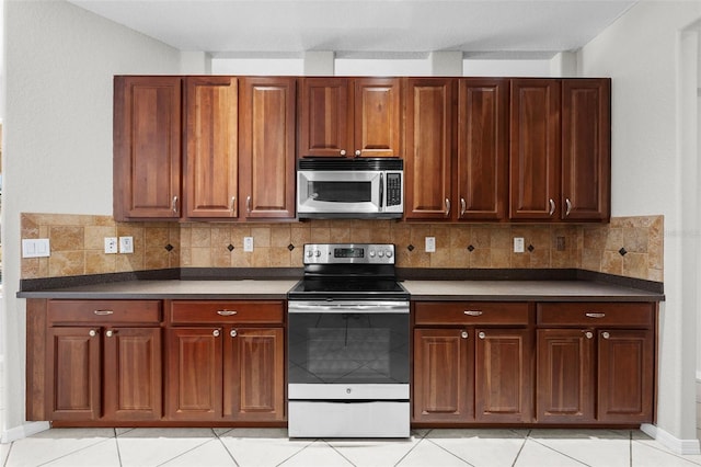 kitchen featuring appliances with stainless steel finishes, tasteful backsplash, and light tile patterned floors