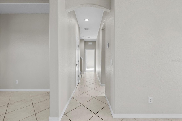 hall with light tile patterned floors