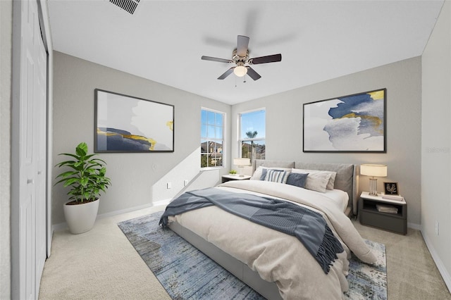 bedroom featuring light carpet and ceiling fan