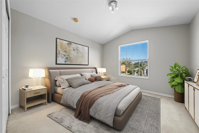 carpeted bedroom with lofted ceiling