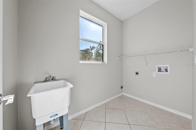 laundry room featuring light tile patterned flooring, hookup for a washing machine, electric dryer hookup, and sink