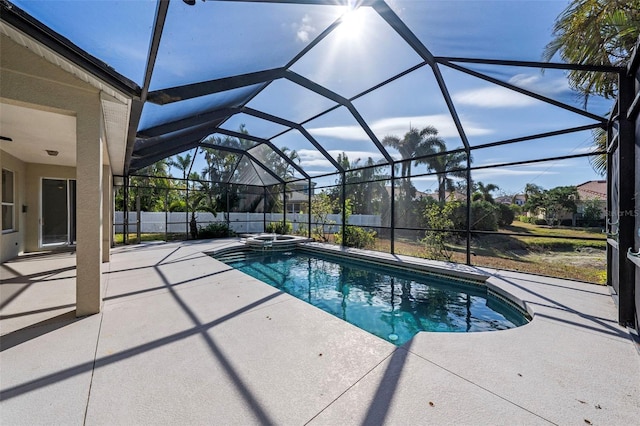 view of swimming pool with glass enclosure, a patio area, and an in ground hot tub