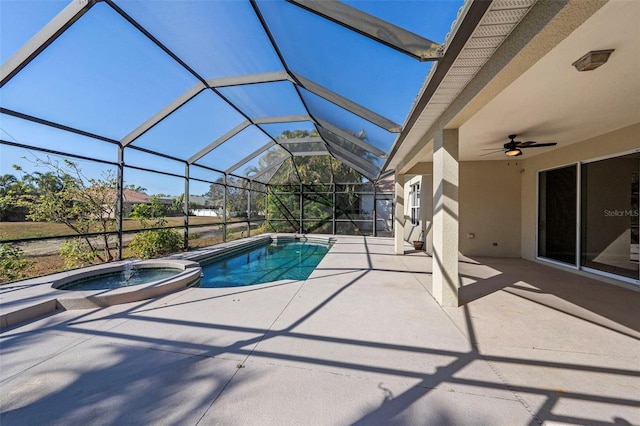 view of pool with a lanai, a patio area, and an in ground hot tub