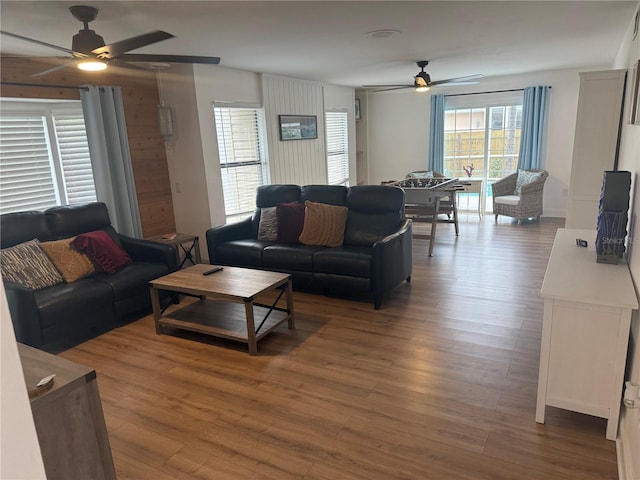 living room with hardwood / wood-style flooring and ceiling fan