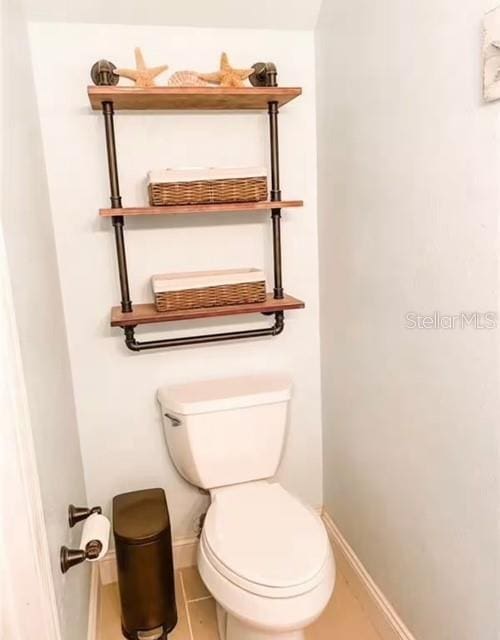 bathroom featuring tile patterned flooring and toilet