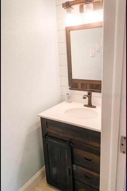 bathroom with tile patterned flooring and vanity