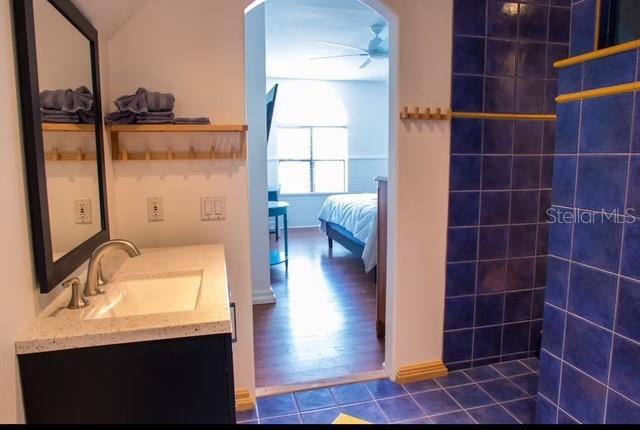 bathroom featuring ceiling fan and vanity