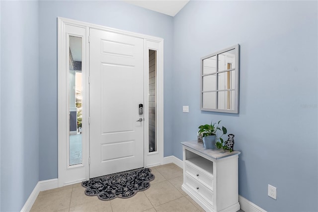 foyer entrance with light tile patterned floors